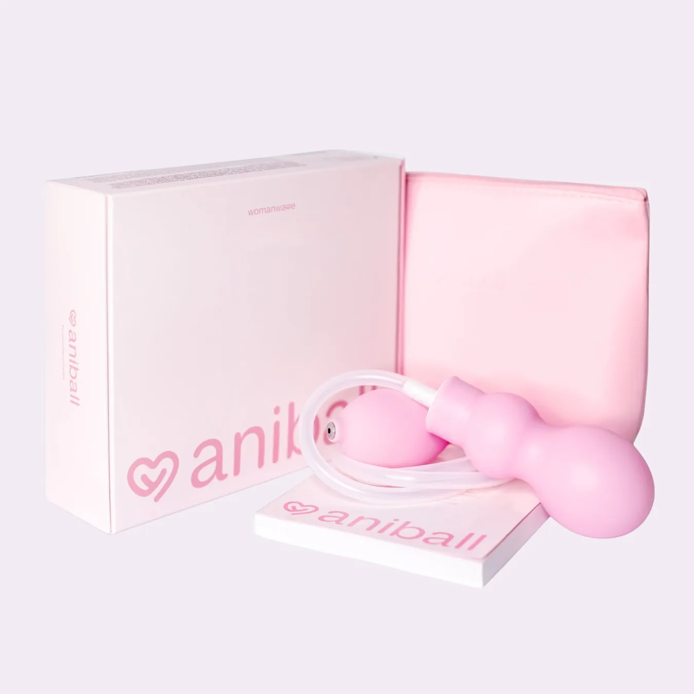 Aniball complete set showing the pink balloon, hand pump, tubing, carry pouch, packaging and booklet