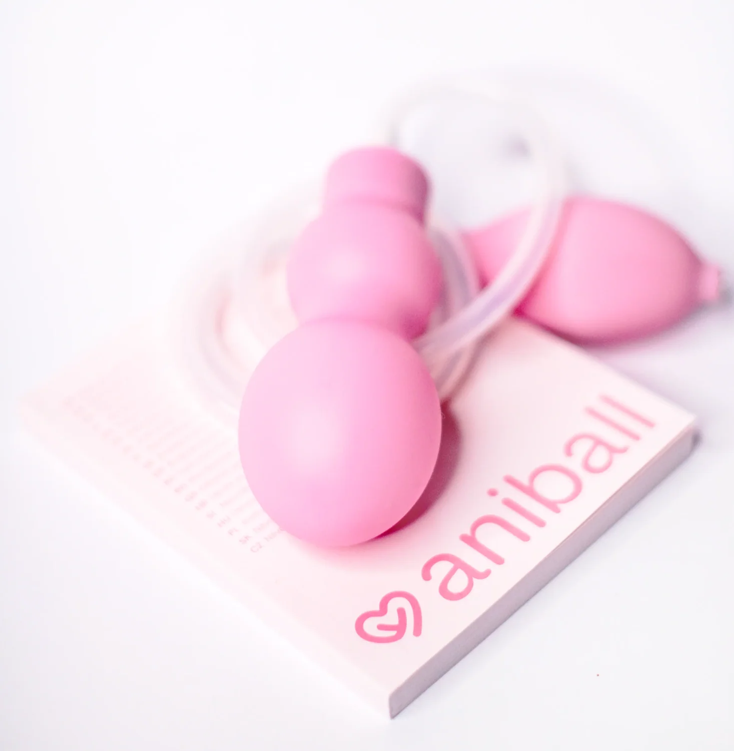 Aniball pink balloon, tubing and pump with branded educational booklet